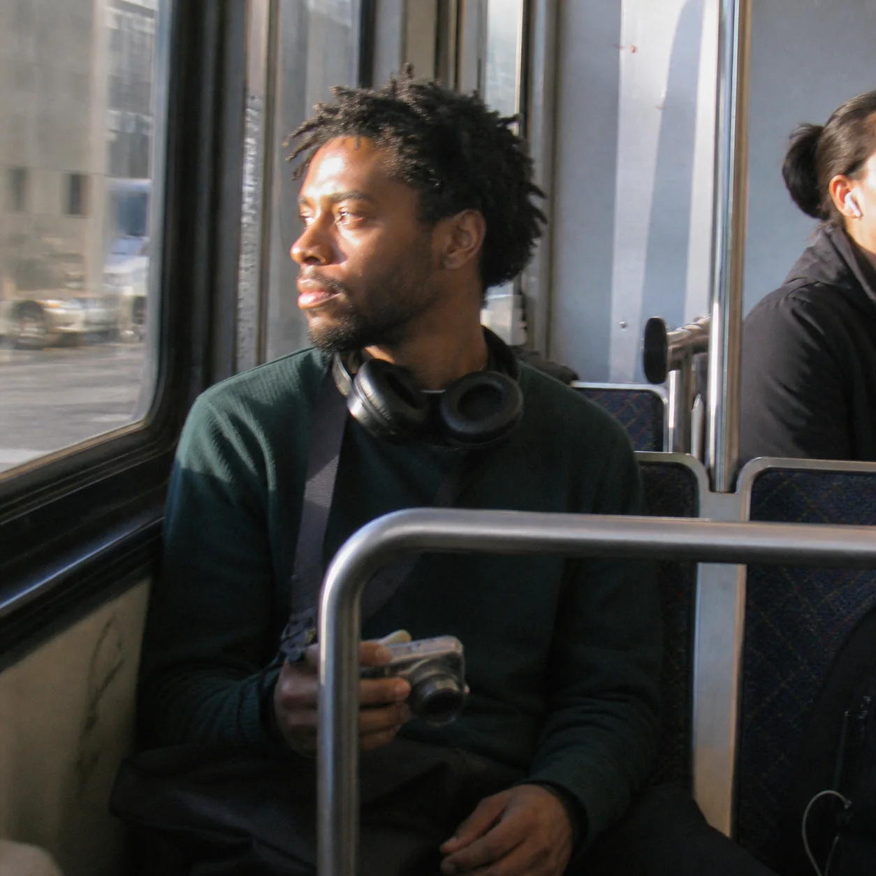 Creator carrying a compact camera on the streetcar