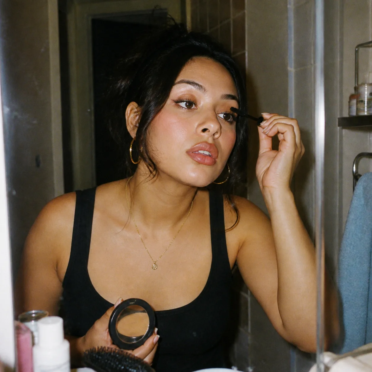 Beauty creator getting ready in her apartment mirror