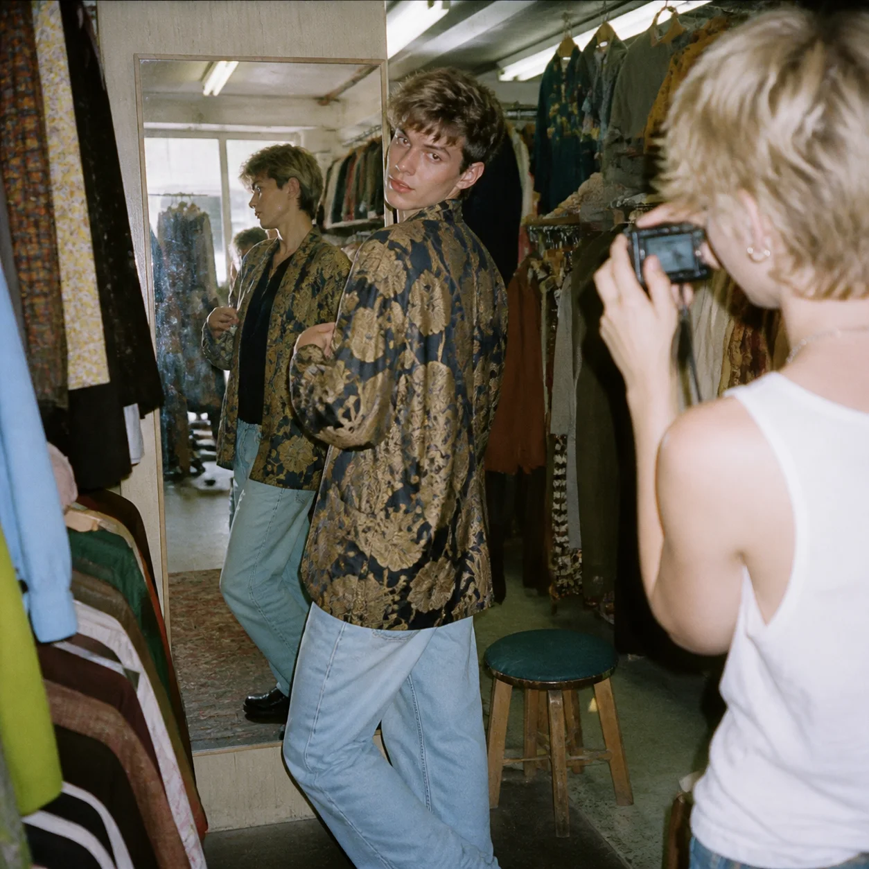 Fashion creator trying on a jacket in a vintage shop